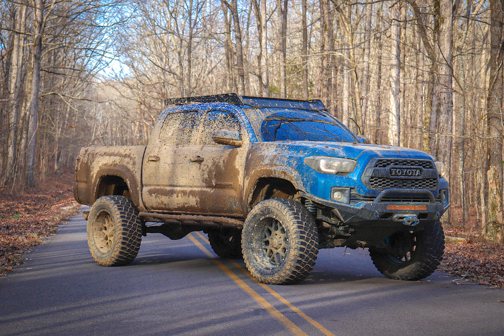 Lifted Blazing Blue Pearl Tacoma with King Off-Road Coilover Shocks