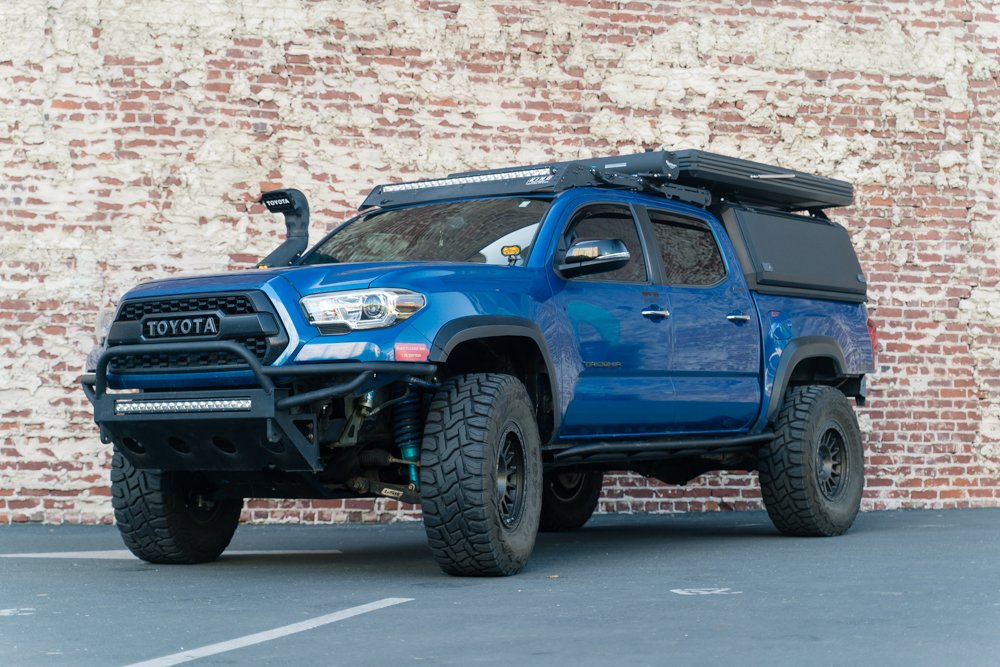 Lifted Blazing Blue Pearl Tacoma on 35 Inch Tires with AreaBFE Tent