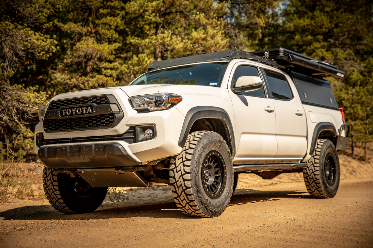 Lifted Super White 3rd Gen Tacoma on 34s with Relations Race Wheels Bolt-On Rock Sliders