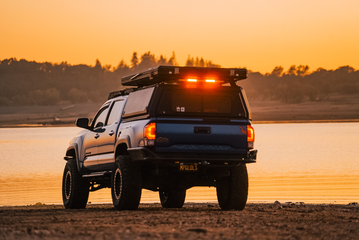 Lifted Blazing Blue Pearl 3rd Gen Tacoma with CampKing Bed Topper and RLB LED Chase Lights