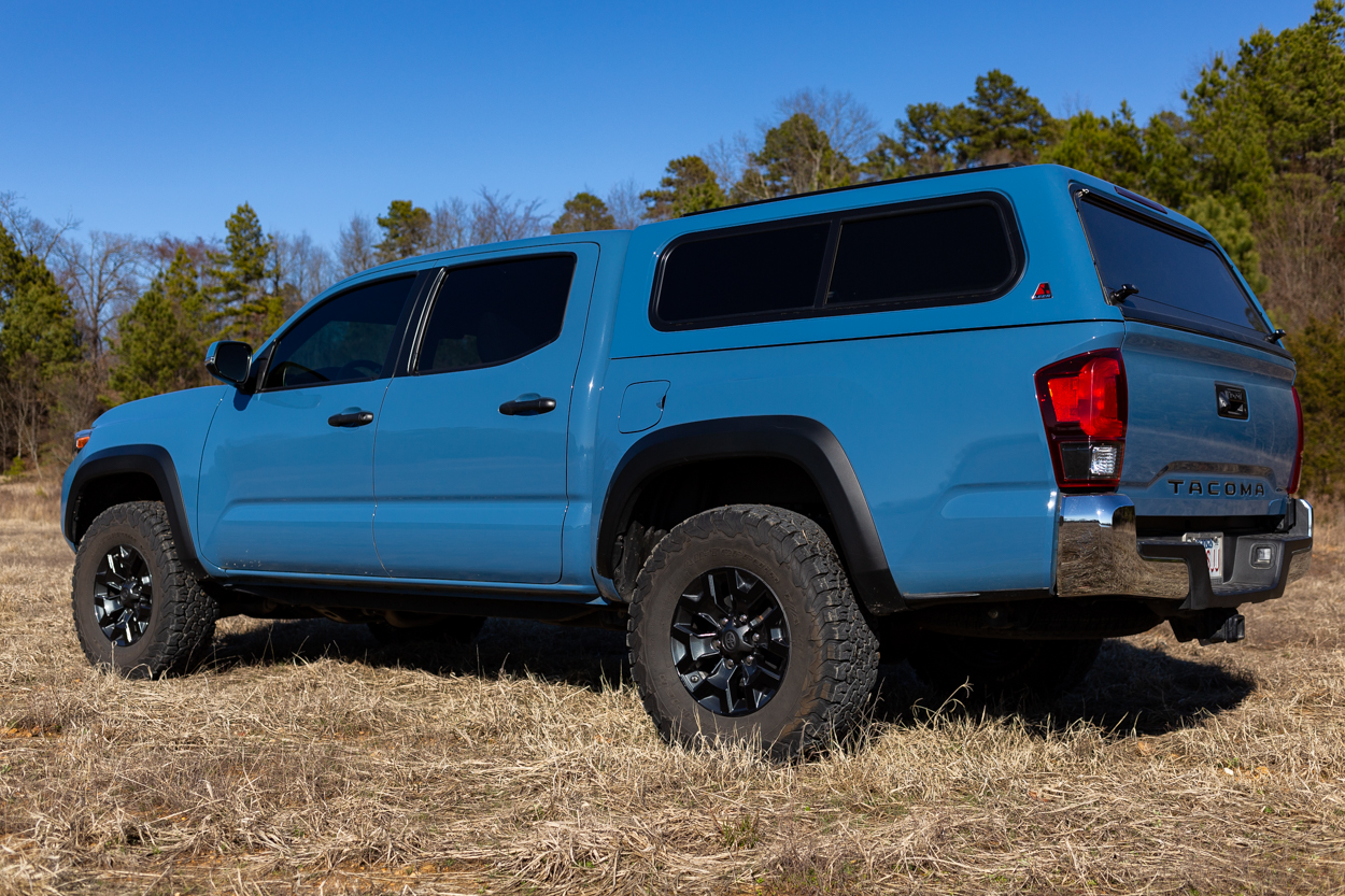 Cavalry Blue Toyota Tacoma with Fiberglass Leer Truck Cap & Black OEM W...