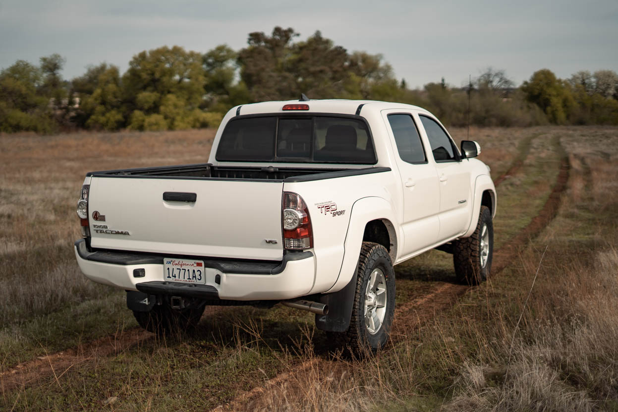 White Toyota Tacoma on a 3" Lift and 33" Yokohama Geolanders