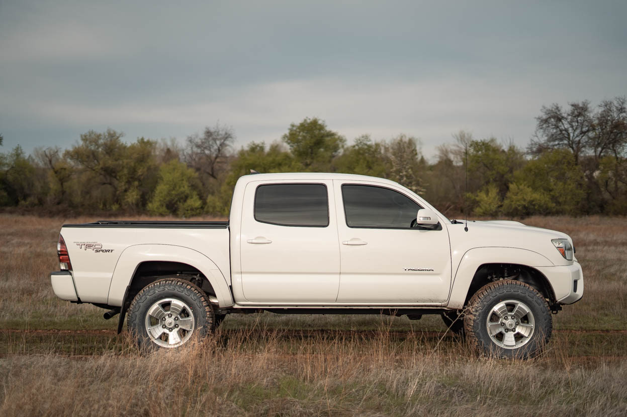 White Toyota Tacoma on a 3" Lift and 33" Yokohama Geolanders