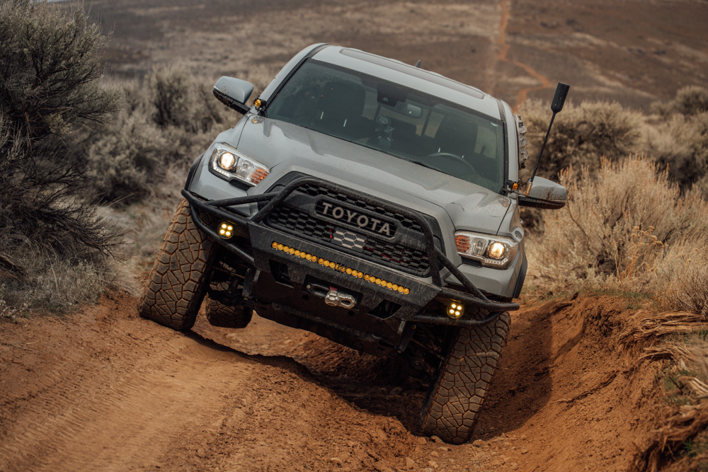 Lifted Cement 3rd Gen Toyota Tacoma with weBoost Drive Reach OTR & C4 Fabrication Front Bumper