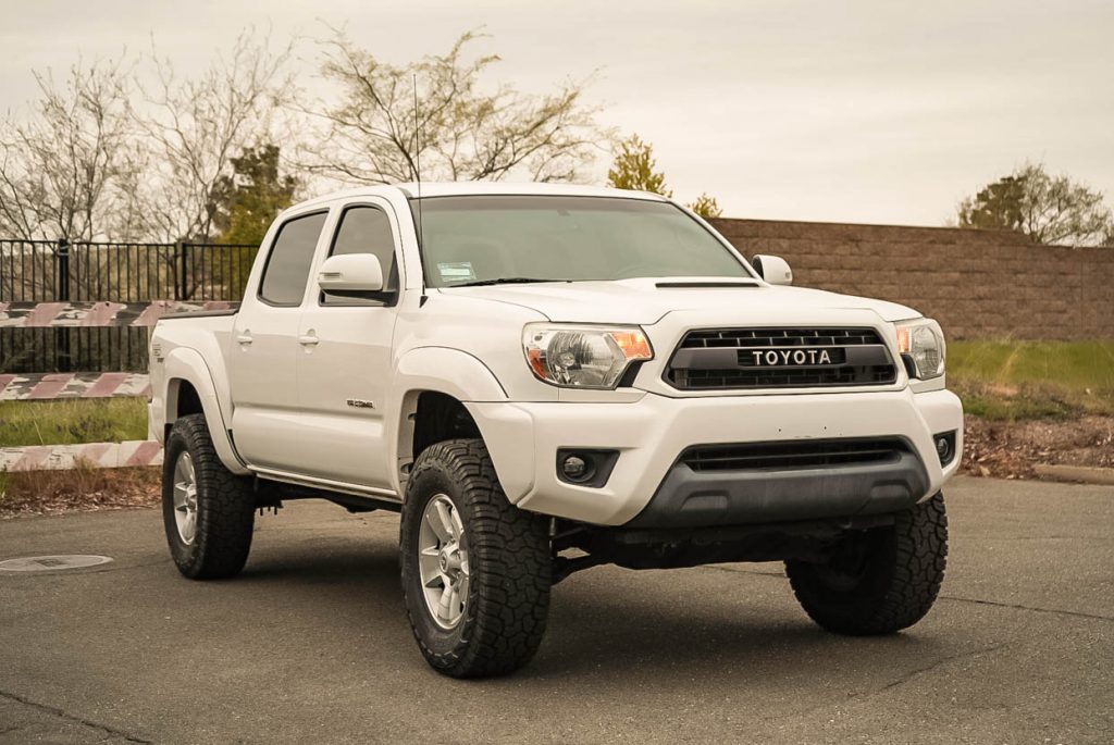 Lifted Super White Toyota Tacoma on 33-Inch Yokohama Geolandar X-AT & TRD Pro Grille