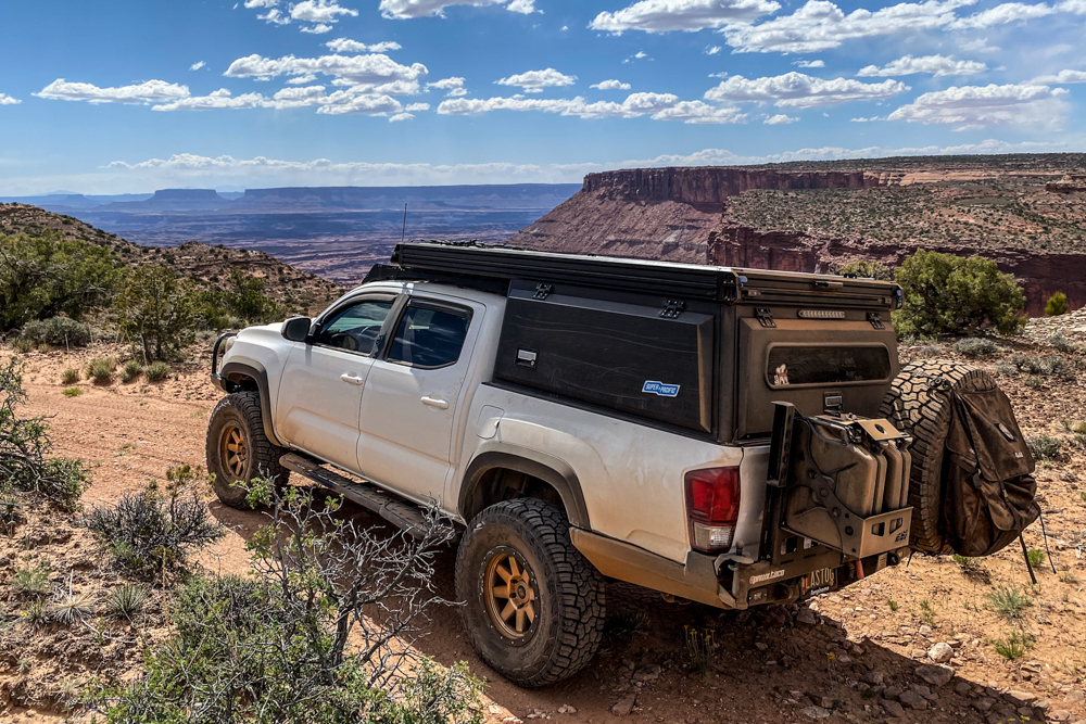 Lifted Super White 3rd Gen Tacoma with Black Super Pacific Camper & CBI Offroad Fabrication Rear Bumper