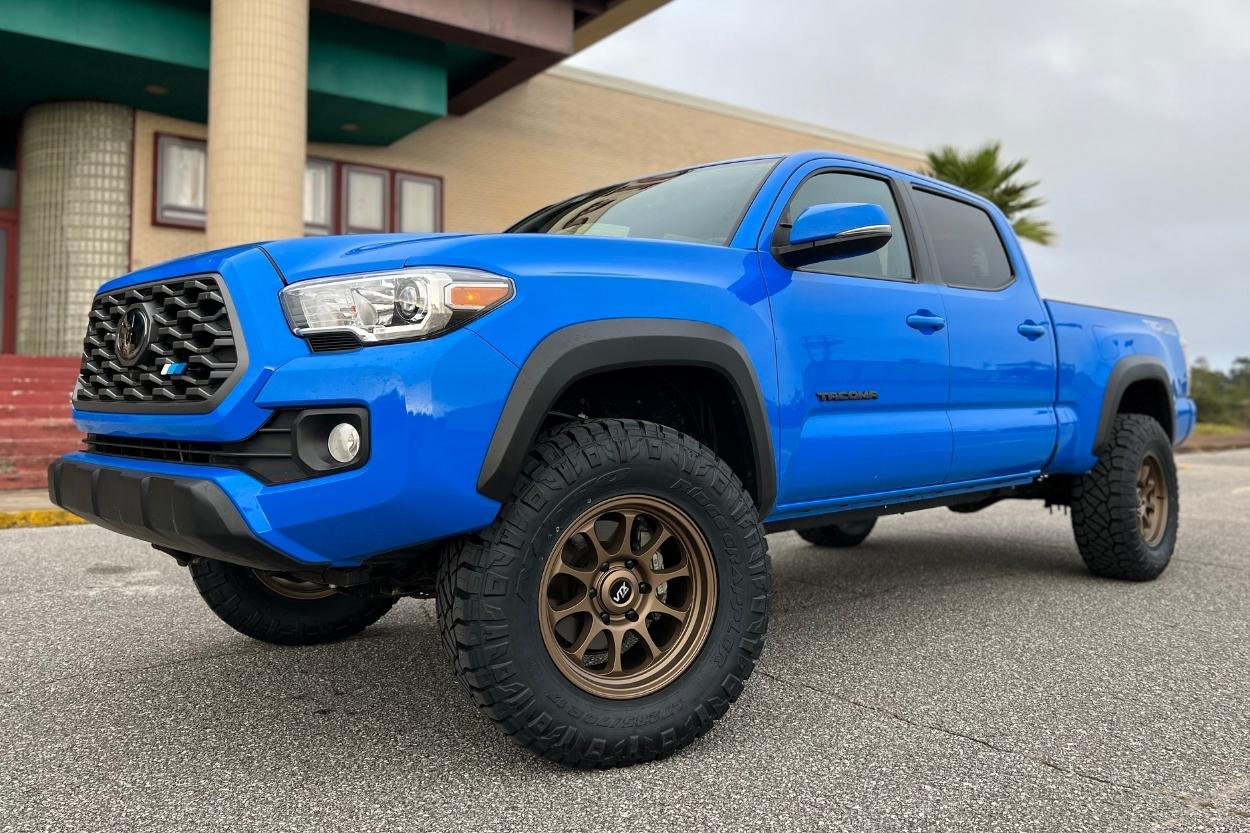 Voodoo Blue 3rd Gen Long Bed Tacoma with Bronze VTX Rogue Wheels & Nitto Ridge Grapplers