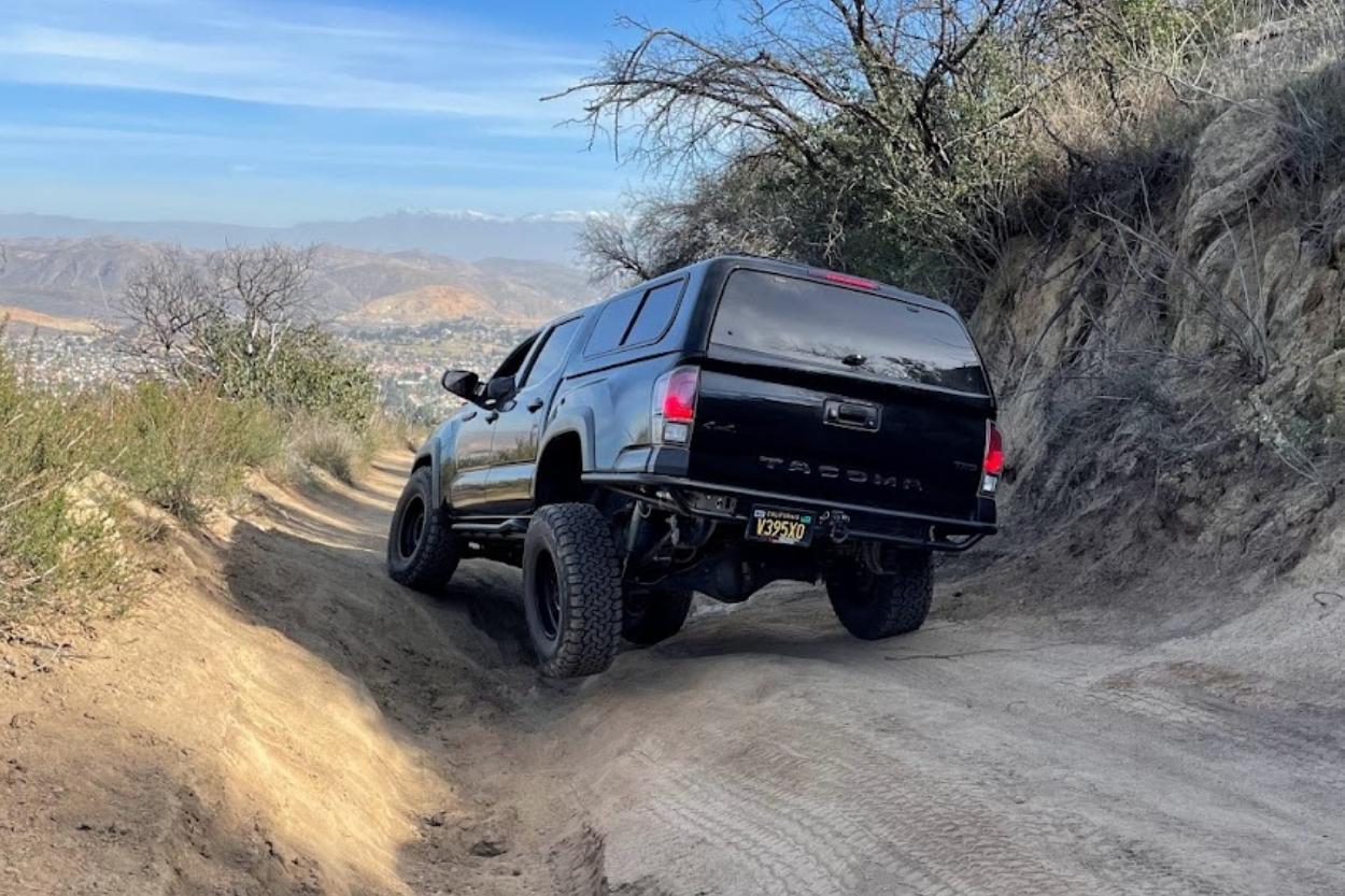 Black 3rd Gen Tacoma with Outgear Solutions High Clearance Rear Tube Bumper & BFG Tires