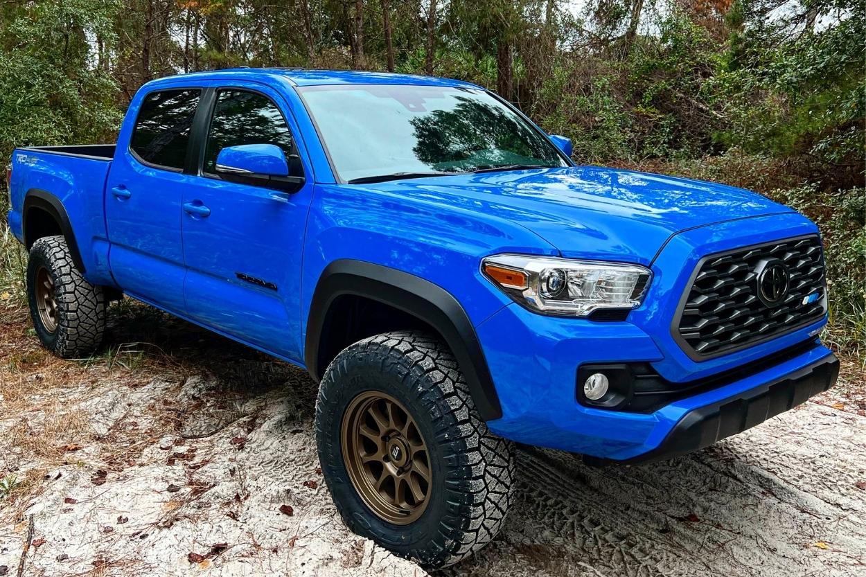 Lifted Long Bed Voodoo Blue 3rd Gen Tacoma with Bronze VTX Wheels