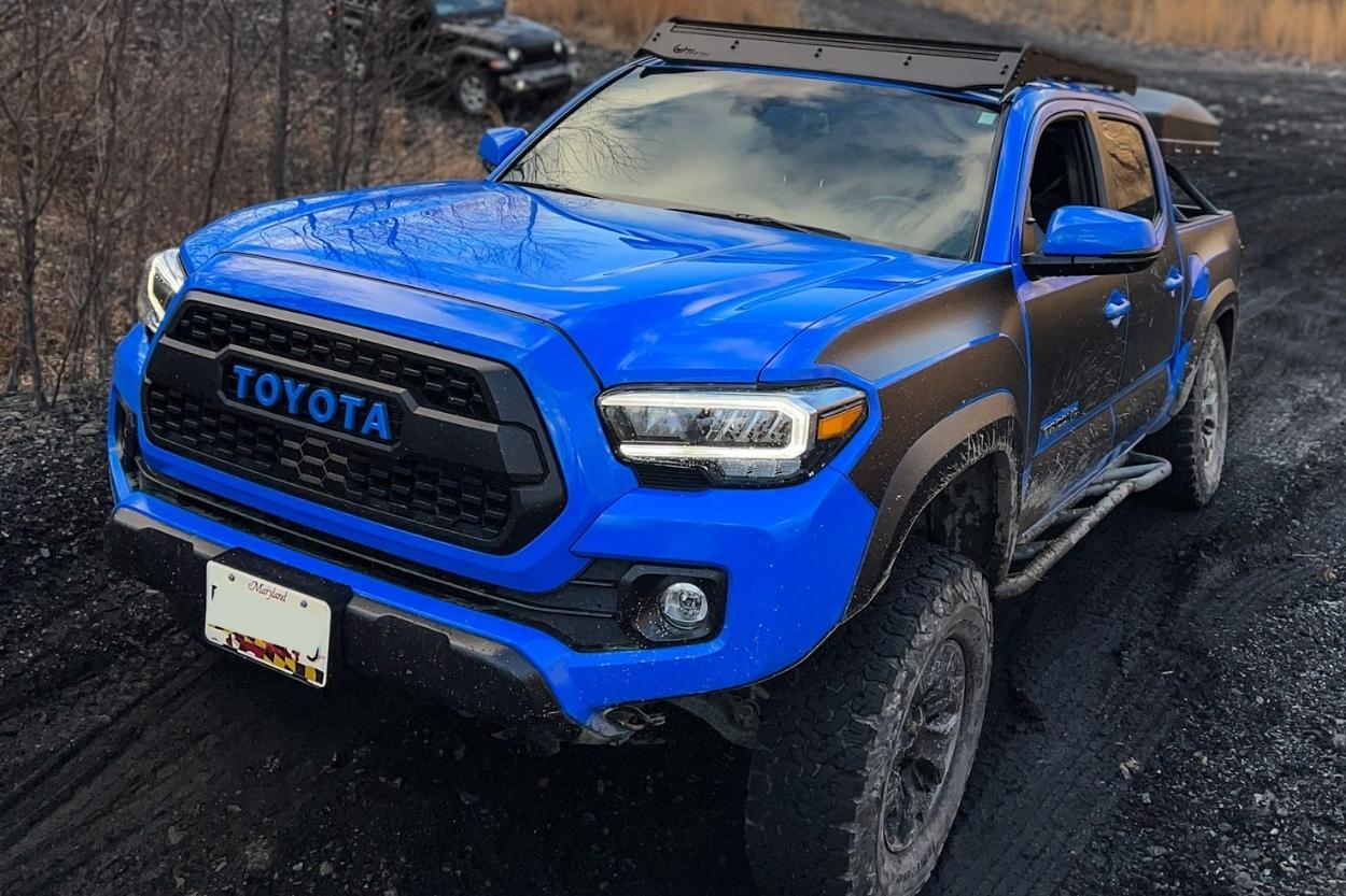 Voodoo Blue 3rd Gen Tacoma with Prinsu Roof Rack, GOAT Truck Armor & Relations Race Wheels Rock Sliders