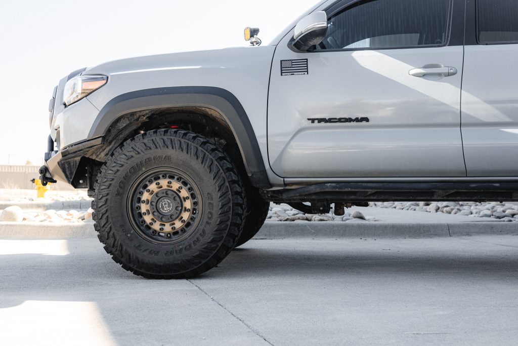 Lifted Cement 3rd Gen Tacoma with Black Rhino Wheels, Yokohama Geolandar M/T Tires, Westcott Designs Rock Sliders