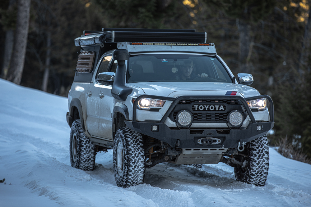 Lifted White Tacoma with Black GFC Camper