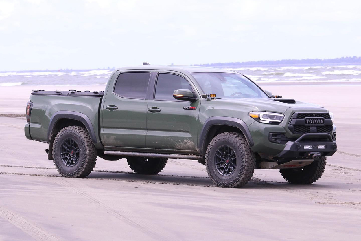 Army Green Tacoma with Victory 4x4 Blitz Front Bumper and Cali Raised Off-Road Rock Sliders