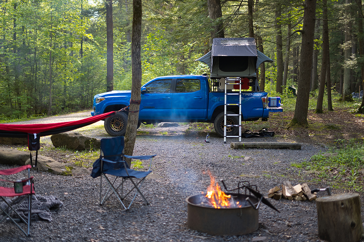 Voodoo Blue Toyota Tacoma with Bronze Wheels & Roof Top Tent