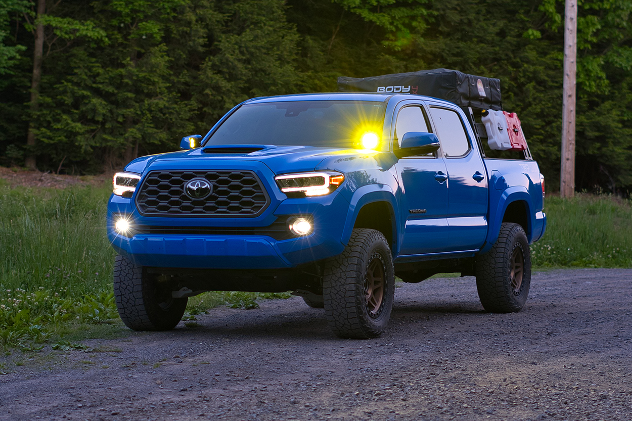 Voodoo Blue Toyota Tacoma with Body Armor 4x4 Sky Ridge Pike RTT & Amber Ditch Lights