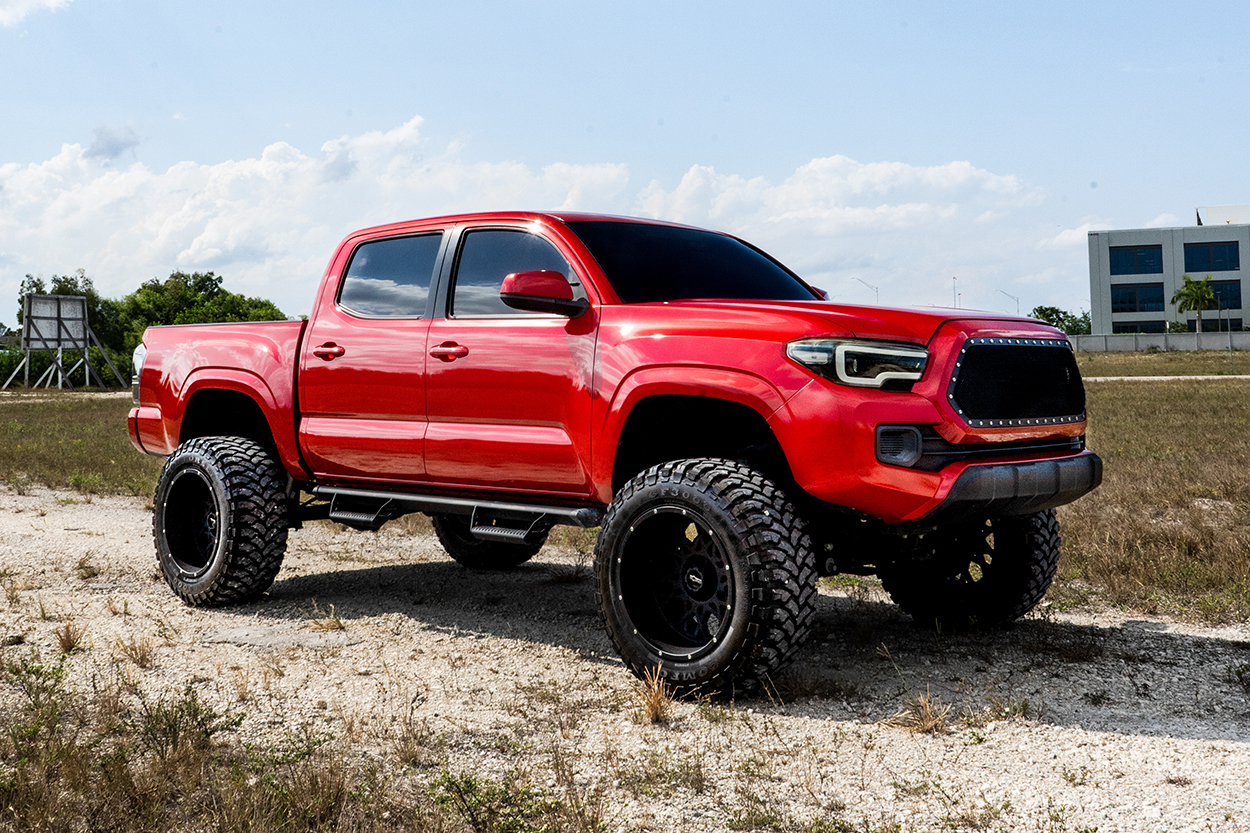 Barcelona Red Toyota Tacoma With Drop Bracket Lift & Custom Grille