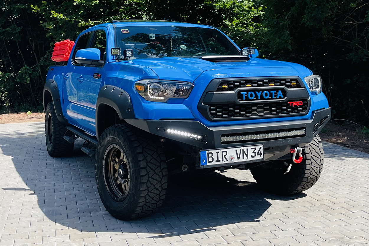 Voodoo Blue Tacoma with Addictive Desert Designs Honey Badger Bumper