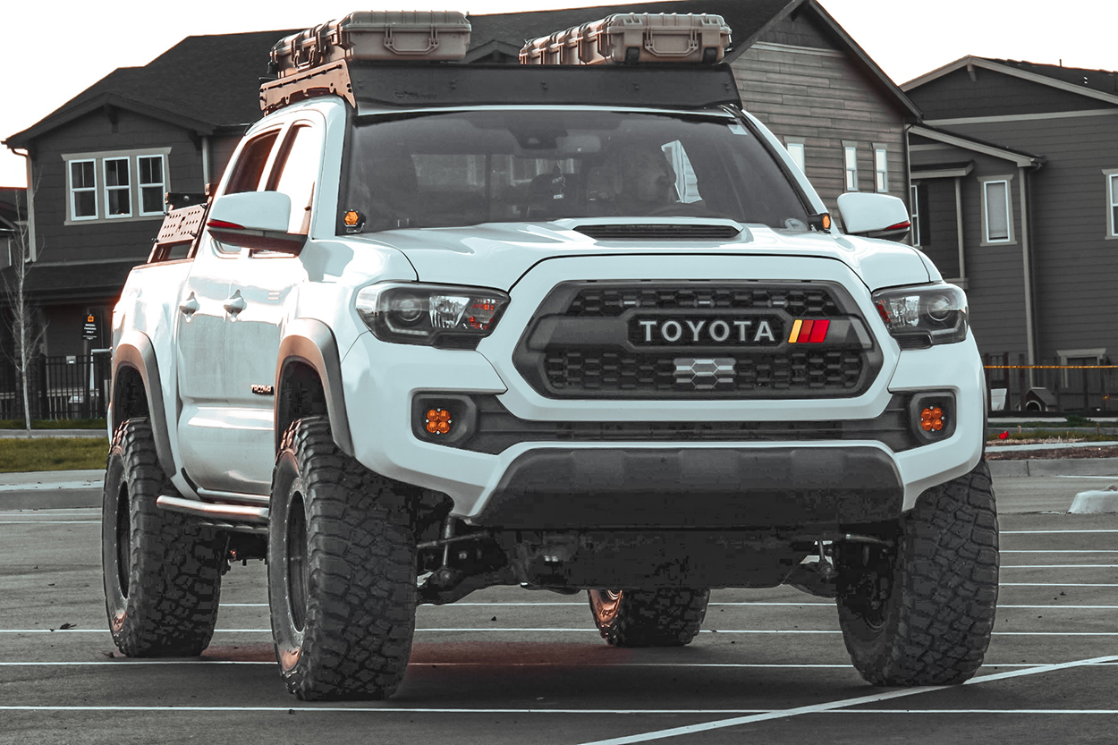 White 3rd Gen Tacoma with RCI 20-Degree w/ Kick-Out Rock Sliders