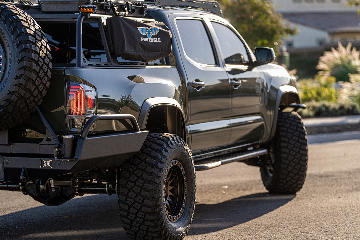 Black Lifted 3rd Gen Toyota Tacoma w/ Kick Out Rock Sliders & Morimoto Tail Lights