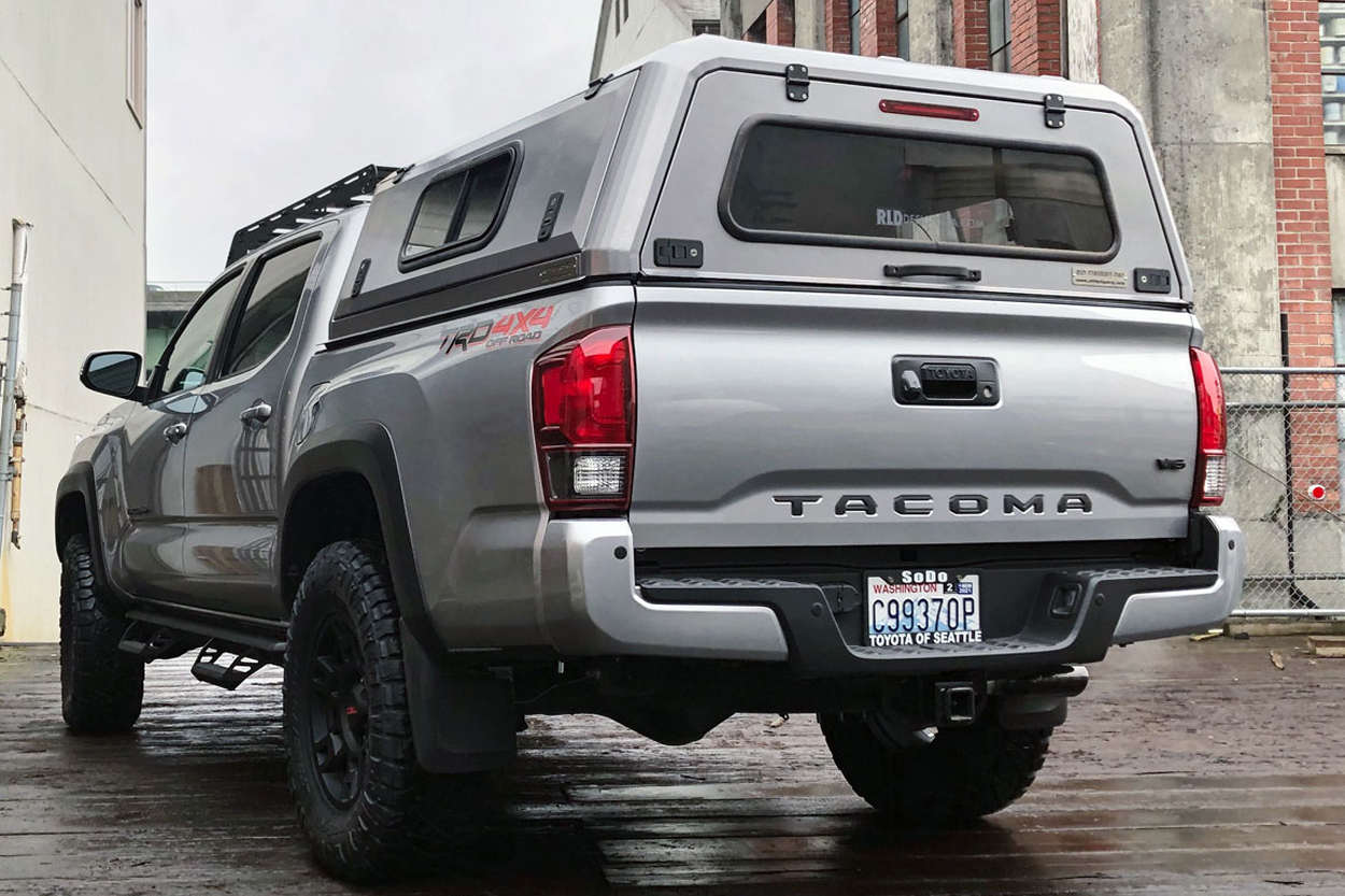 RLD Design Stainless Steel Powder Coated Off-Road Camper Shell Installed On Silver Sky Metallic 3rd Gen Tacoma (2016+) with Prinsu Roof Rack and All-Terrain Tires