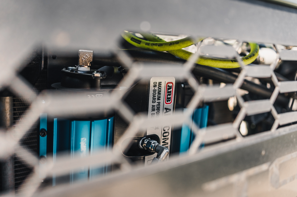 ARB Twin Air Compressor Mounted Behind The Grille On Toyota Tacoma