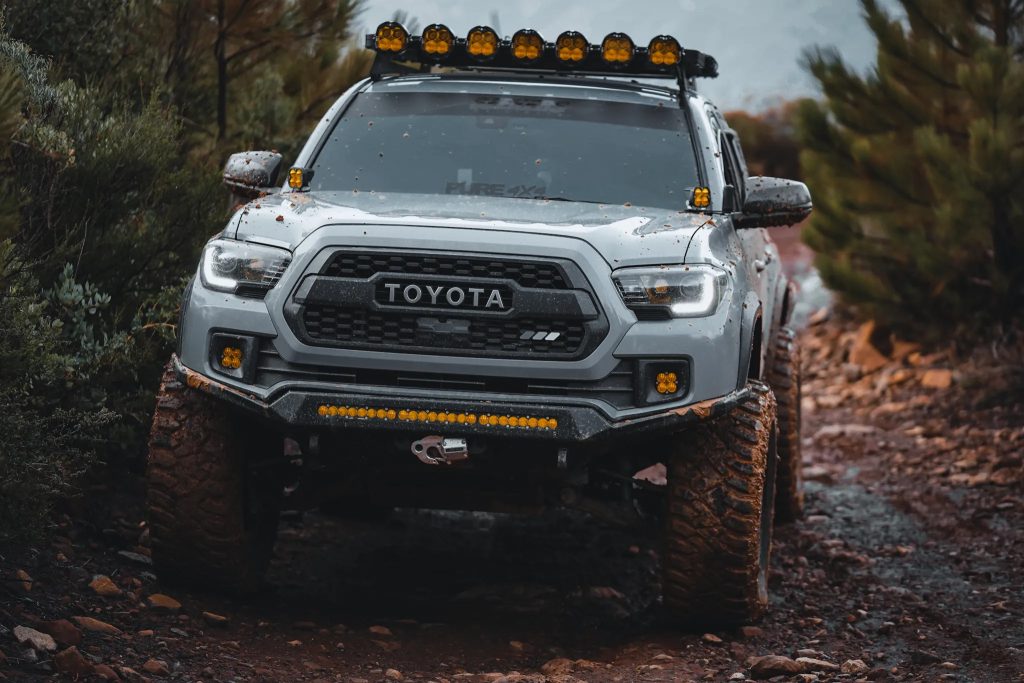 Cement 3rd Gen Tacoma With Custom Retrofit Headlights & Baja Designs LED Lights