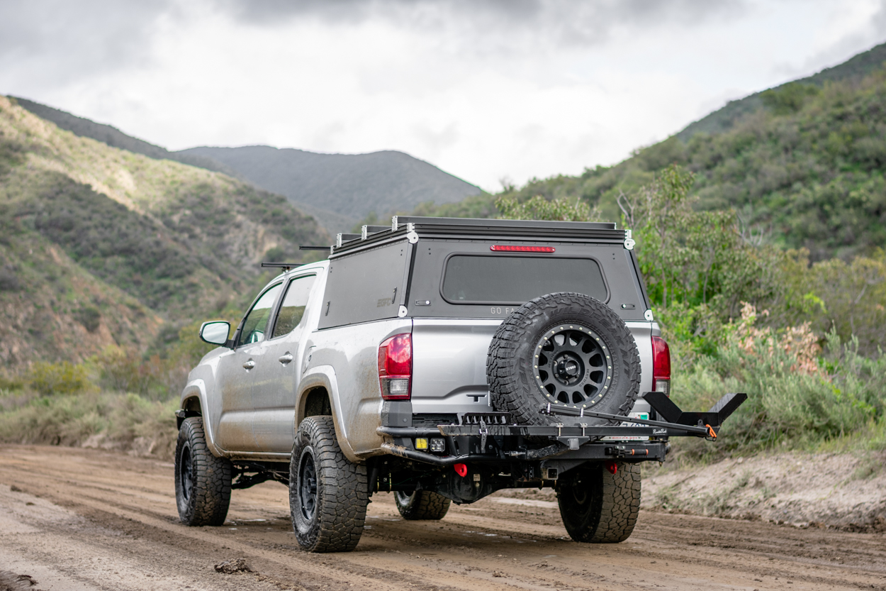 Silver 3rd Gen Tacoma With New GFC Camper Shell, RIGd Supply UltraSwing & RambleRack 