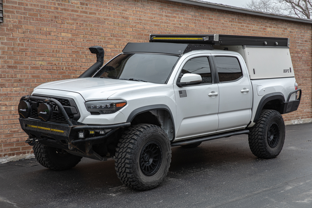 Lifted Super White 3rd Gen Tacoma With White GFC V2 Camper, AL Offroad GFC Roof Rack, ARB Snorkel, 35" ProComp Xtreme MT2 Tires, RRW RR6-H Wheels, AlphaRex Nova Headlights, Lightforce LED Lights & Tinted Front Windshield