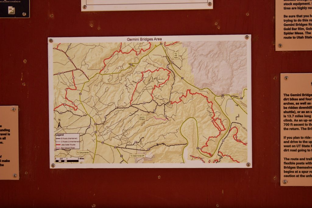 Moab, Utah Gemini Bridges area trail map on trailhead sign.