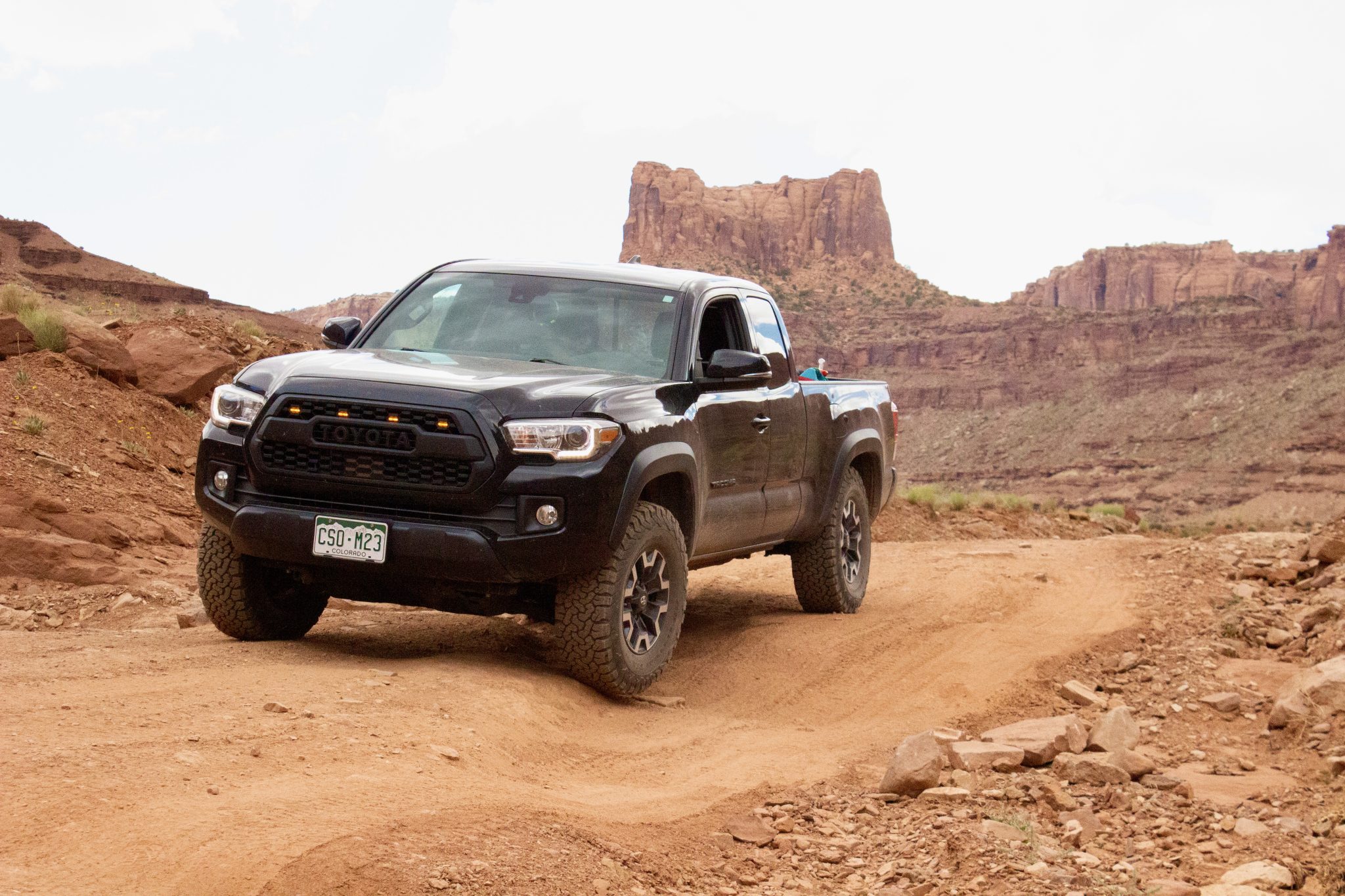 Toyota Tacoma climbing rocky terrain on Moab trail