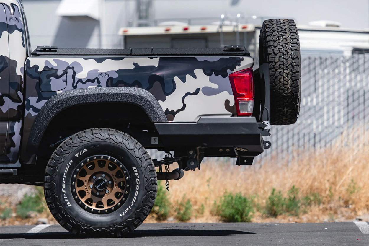 Relentless Fabrication Off-Road Rear Bumper With Spare Tire Carrier Swingout on Custom Camo Wrapped 3rd Gen Tacoma, Method NV Wheels, and BFG KO2 All-Terrain Tires