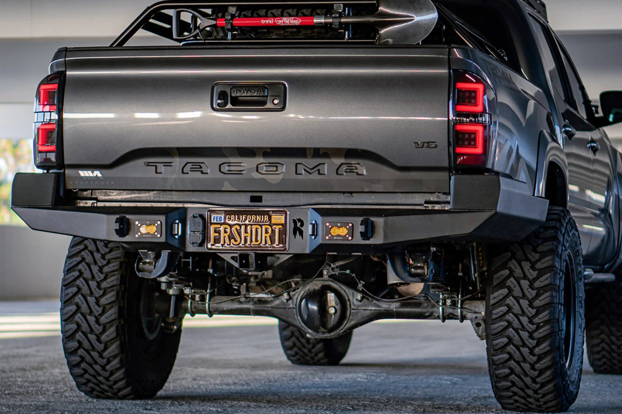 Relentless Fabrication Aftermarket Rear Bumper with High-Clearance Design and Baja Designs S2 Flush Mounted Backup Light Pods on a Lifted Magnetic Gray Metallic 3rd Gen Tacoma 