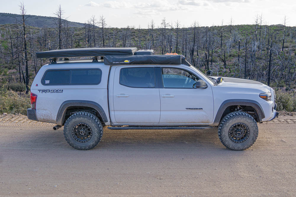 Lifted 3rd Gen Tacoma Overland Build With ARE Topper, Method Wheels & Restless Offroad Fabrication Rock Sliders With Kickout