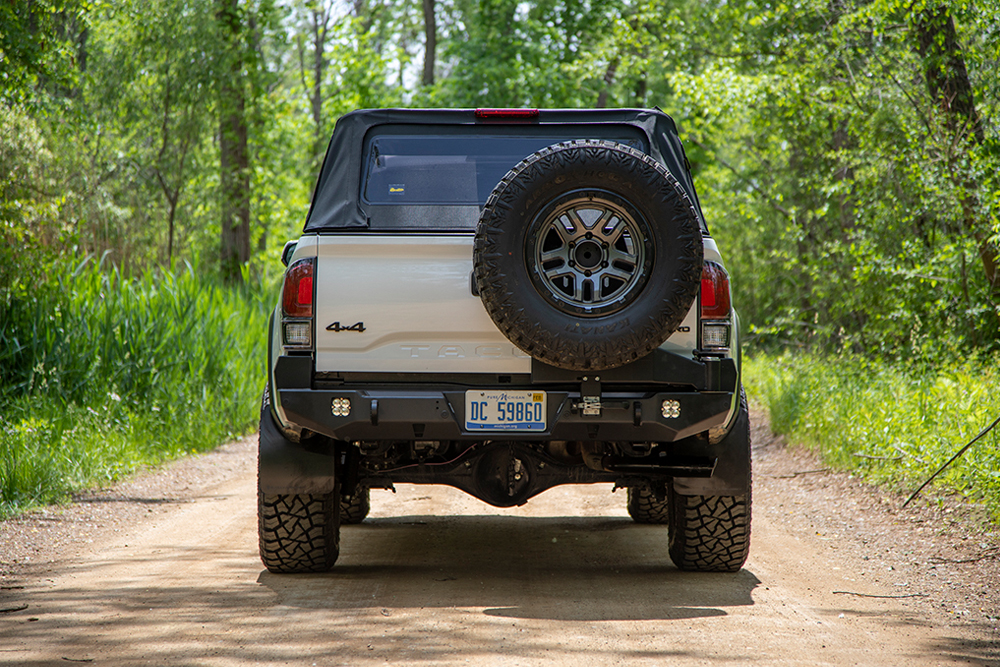 Victory 4x4 Aftermarket Rear Bumper With Single Spare Tire Swingout and Baja Designs Squadron Light Pods Installed on Super White 3rd Gen Tacoma TRD Pro