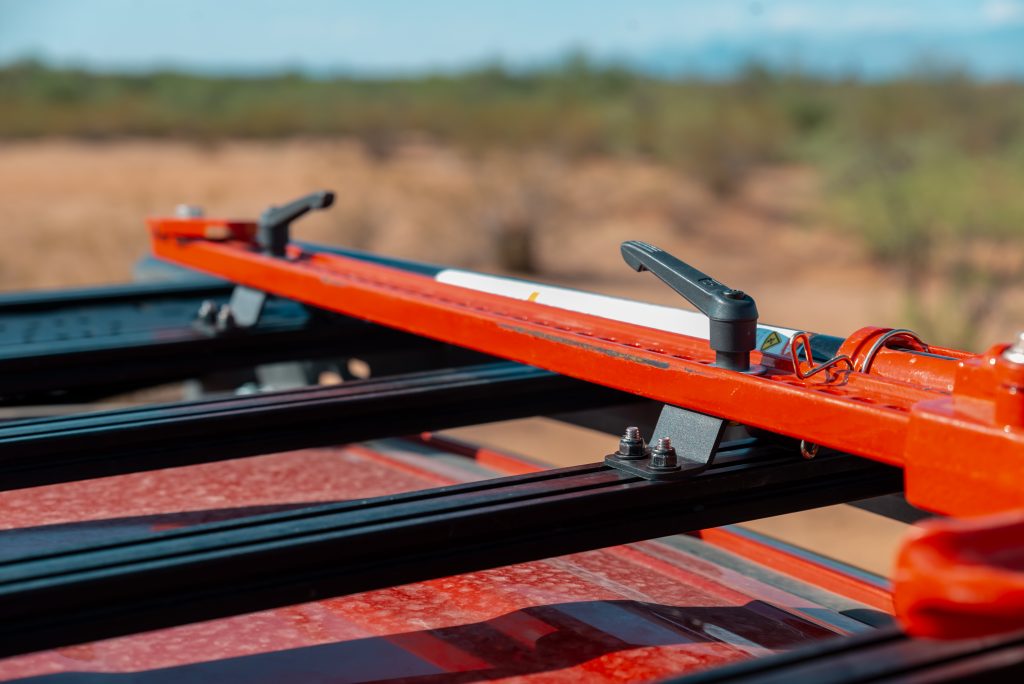 Red Hi-Lift Jack Mounted On A Prinsu Roof Rack On Red Toyota Tacoma