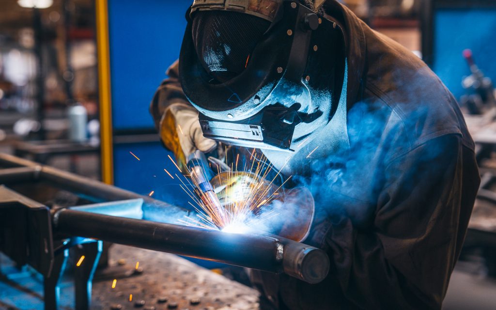 Welder Working On Rock Sliders At Cali Raised Manufacturing Facility