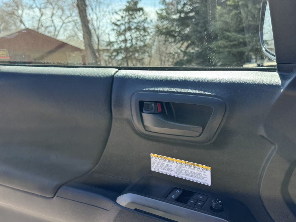 Chrome delete door handle cover modification on the interior of a Toyota Tacoma.