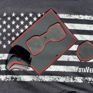 TRD pro style shift knob and interior liners budget mods for Toyota Tacoma on an American flag YotaVerse shirt.